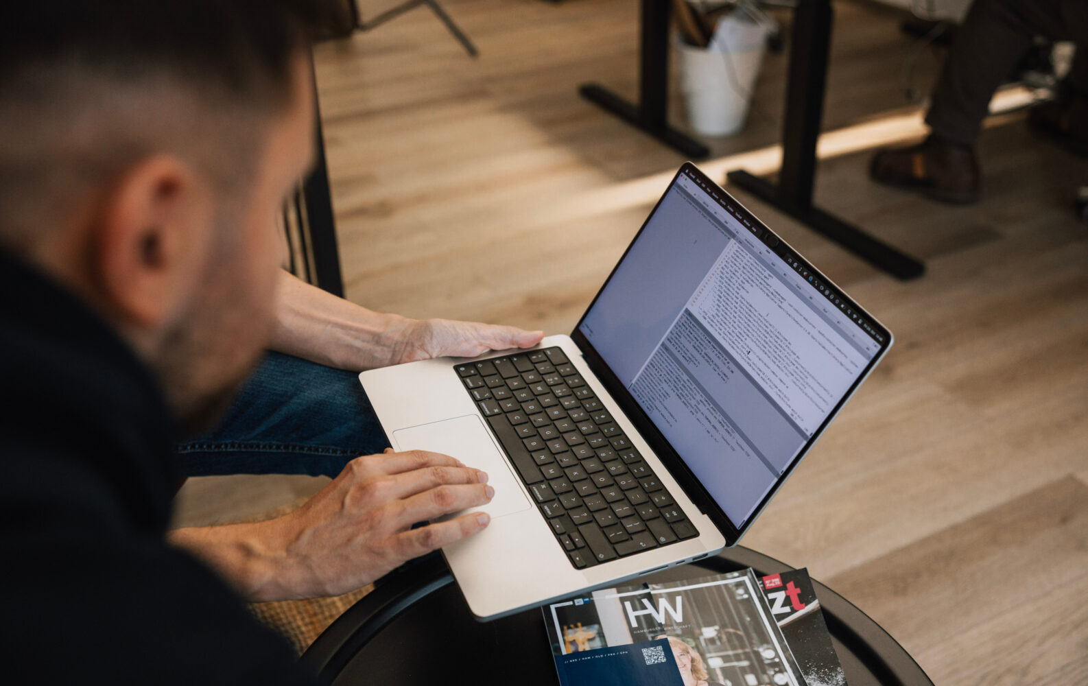 Zwei Personen sitzen an einem Laptop